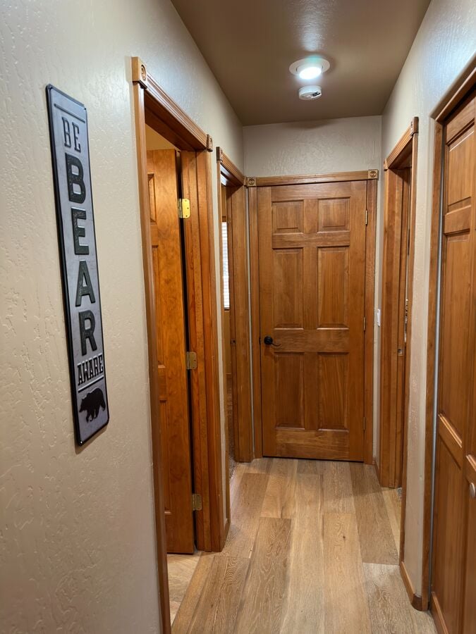 Step down the hall to the two bedrooms and main bath