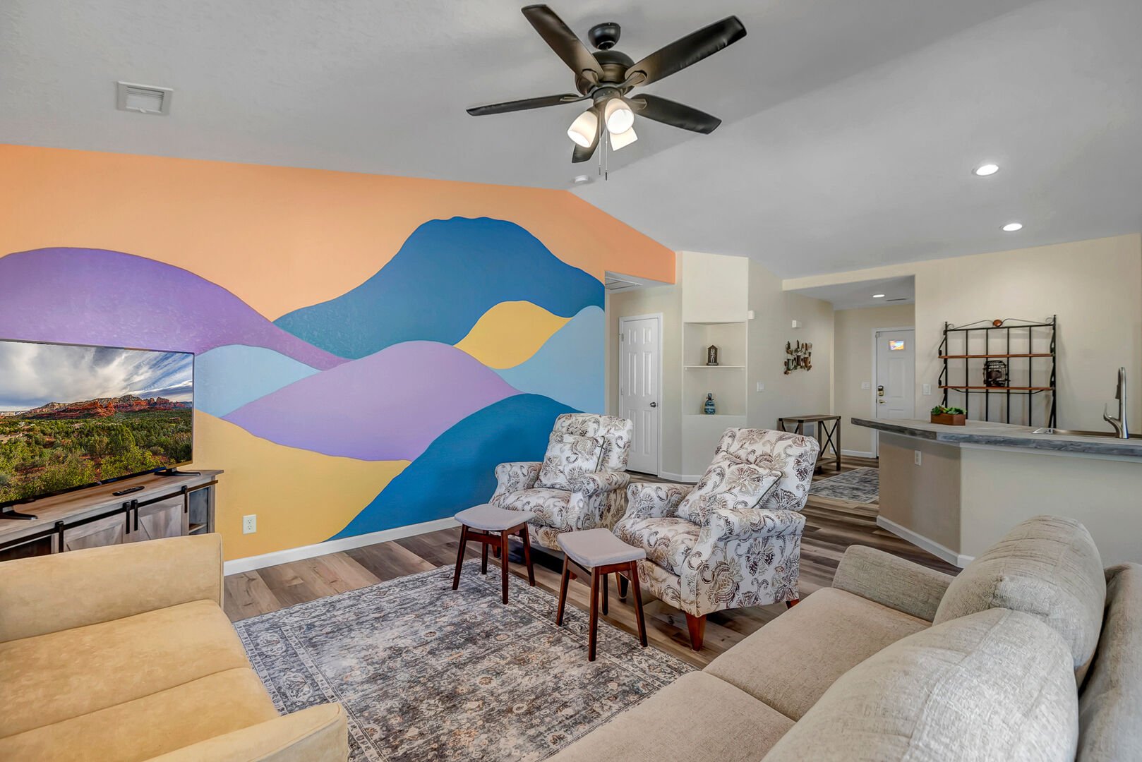 Living Room offers a vibrant accent wall, you'll find cozy seating arrangements and a 50” Smart TV