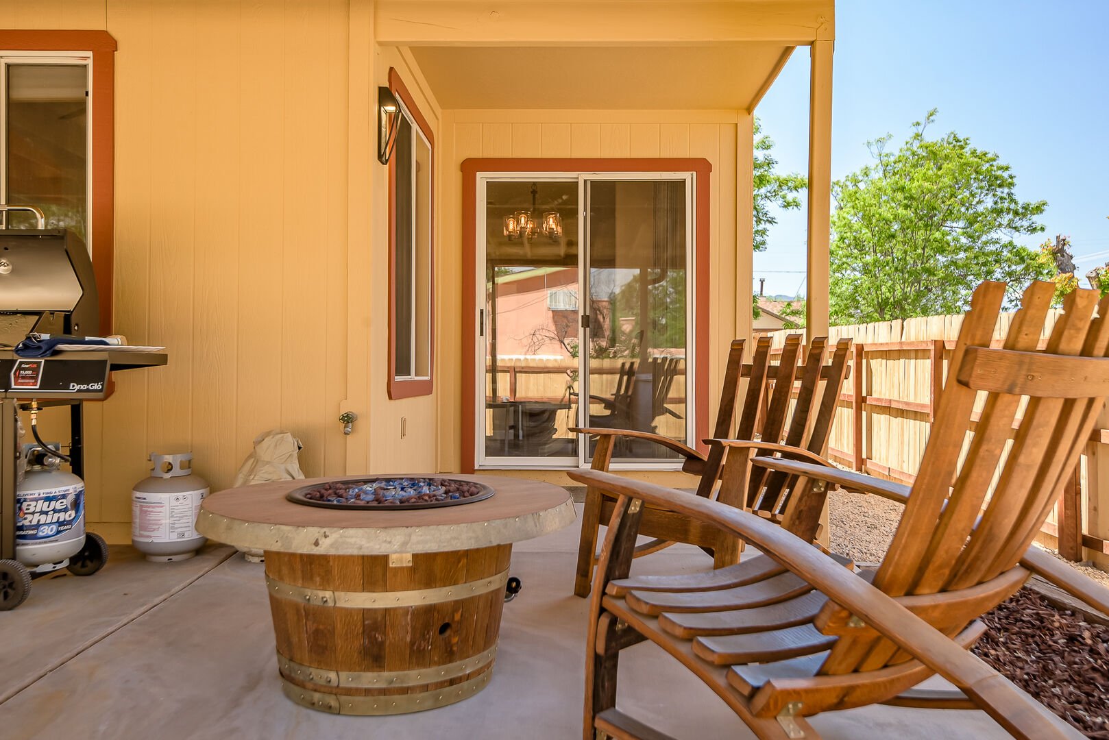 Relax by the custom-made fire pit and chairs crafted from wine barrels