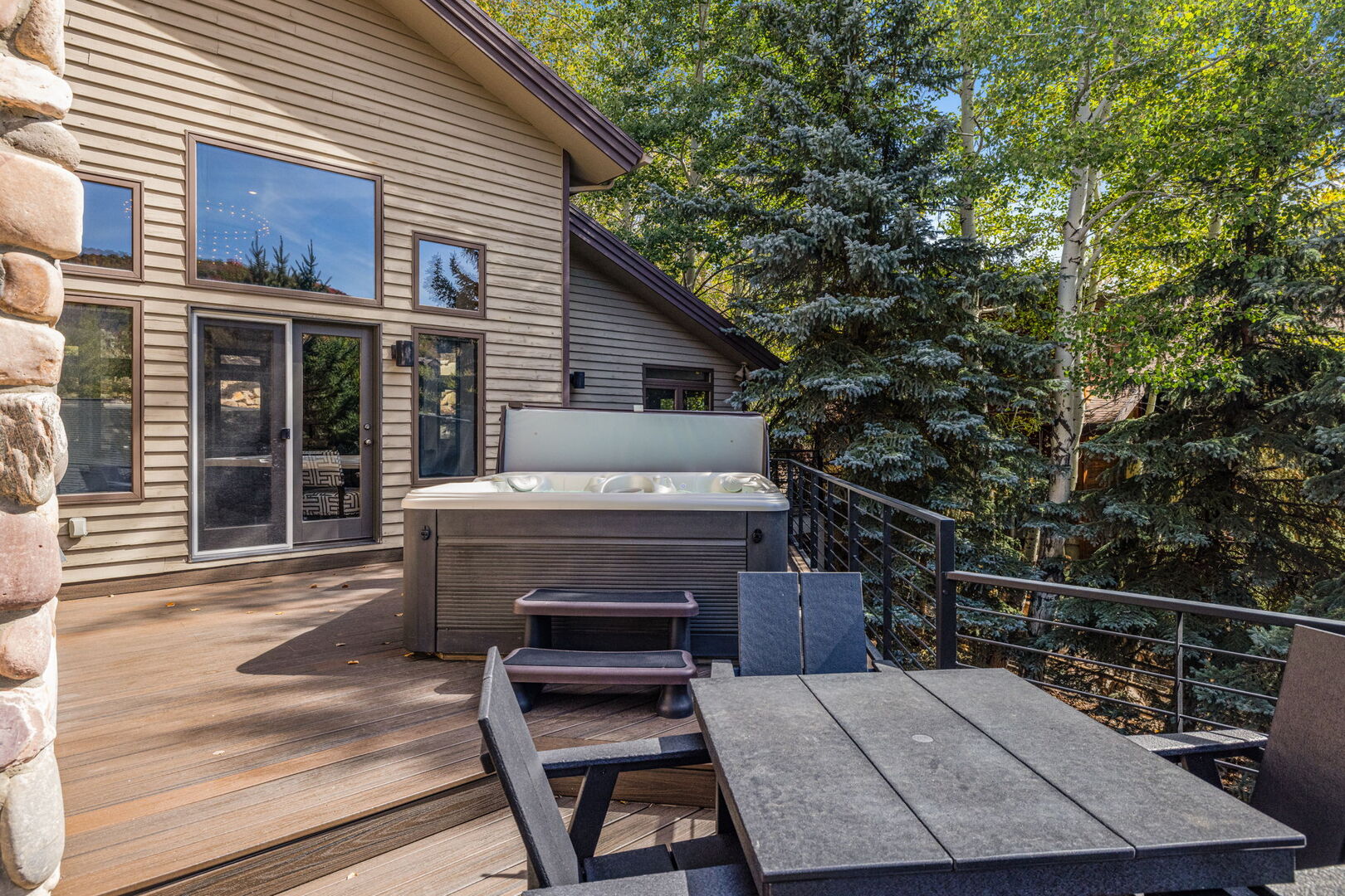 Second Level Deck With Hot Tub and Outdoor Dining Table.