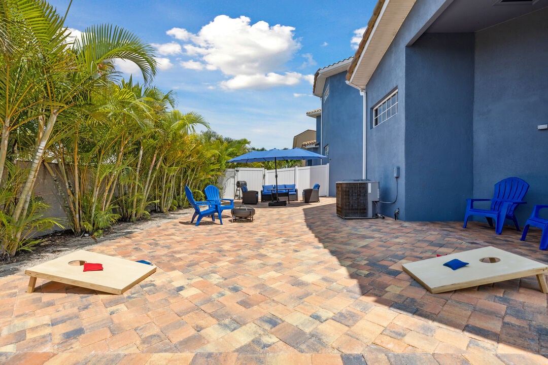 Enjoy a family game of corn hole in the backyard oasis!