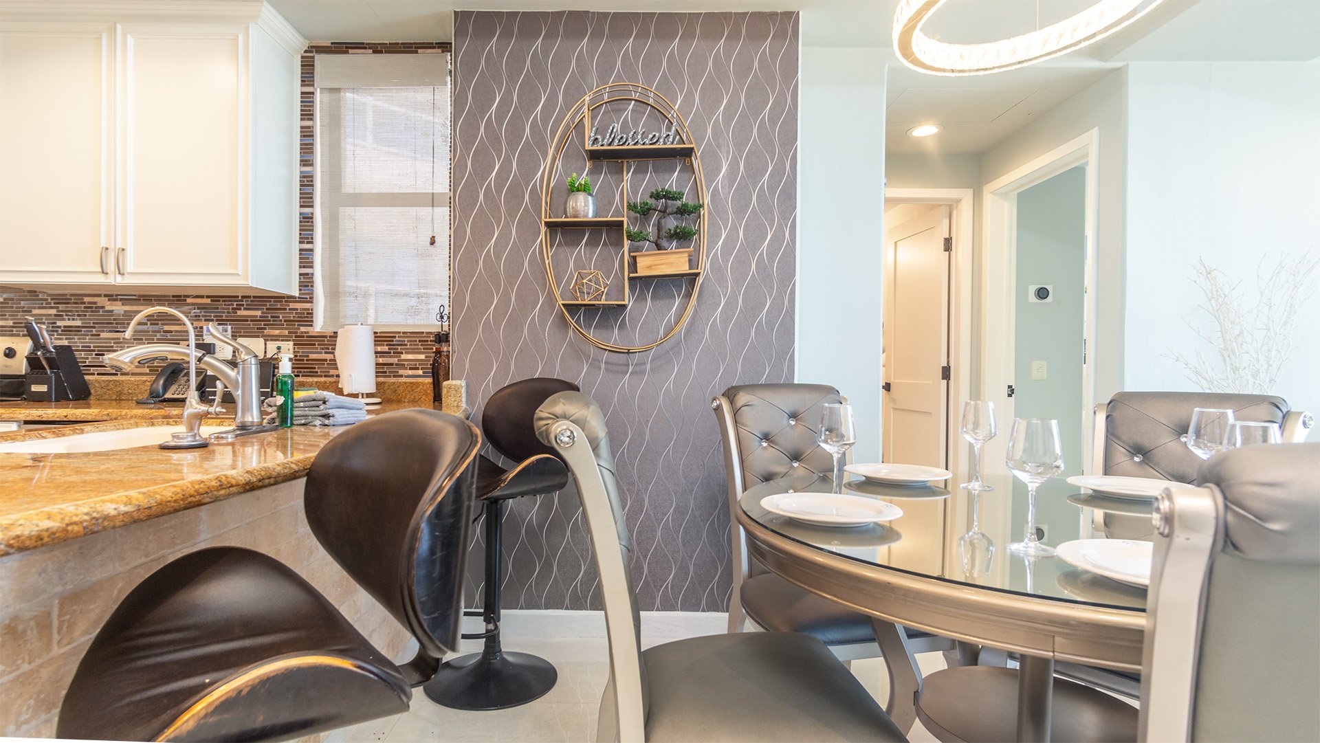 The dining table is next to the kitchen counter.