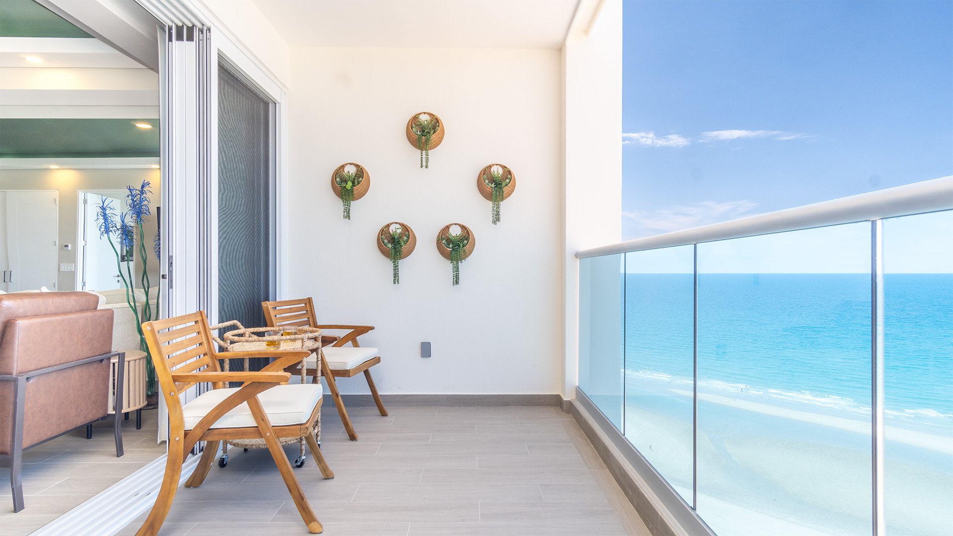 The sliding doors to the balcony open wide to let in the beach ambiance.