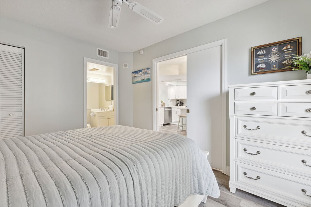 Comfortable guest bedroom with a neatly made bed and spacious storage.