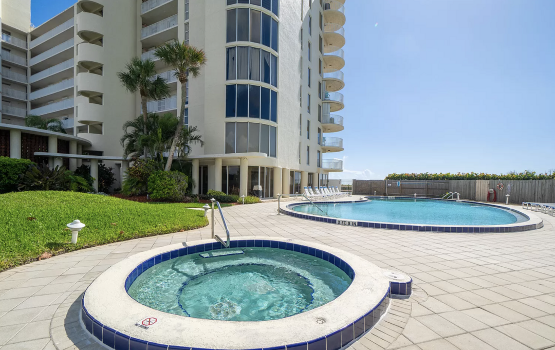 Resort-style hot tub and pool area with a relaxing outdoor atmosphere, perfect for unwinding.