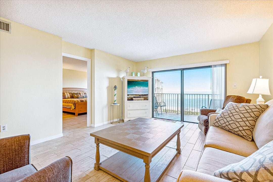 Relax in a bright, cozy living room with stunning ocean views.