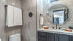 hall bathroom with shower and vanity