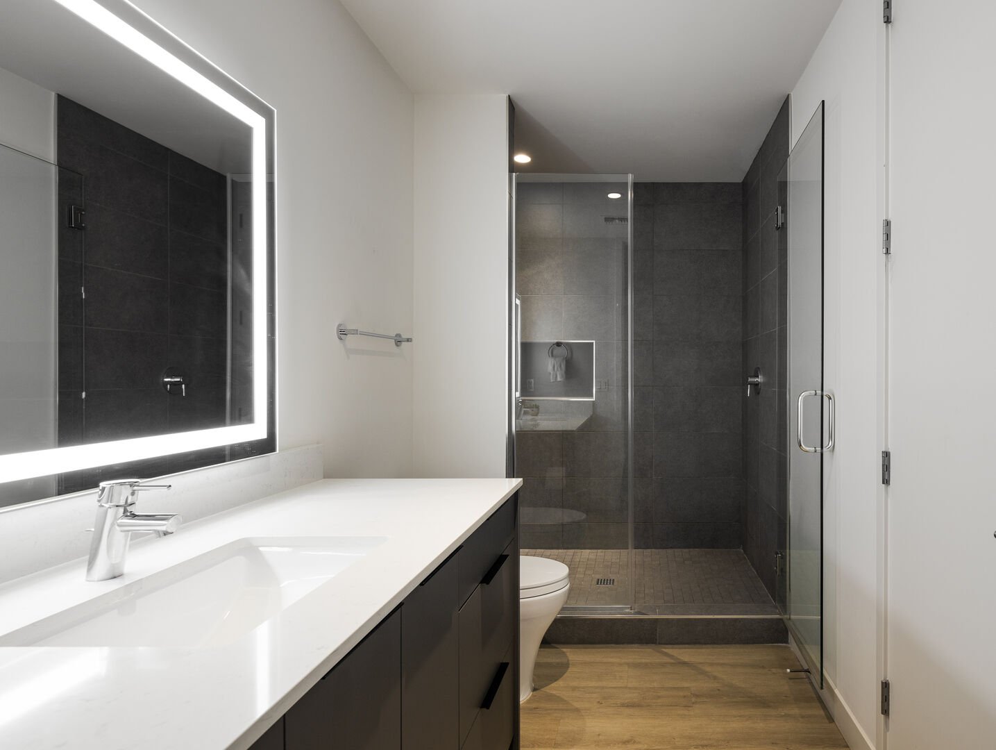 Unit 1 - 2nd Floor: Primary Bathroom featuring a oversized single vanity, a luxurious stand-in shower and a walk-in closet.