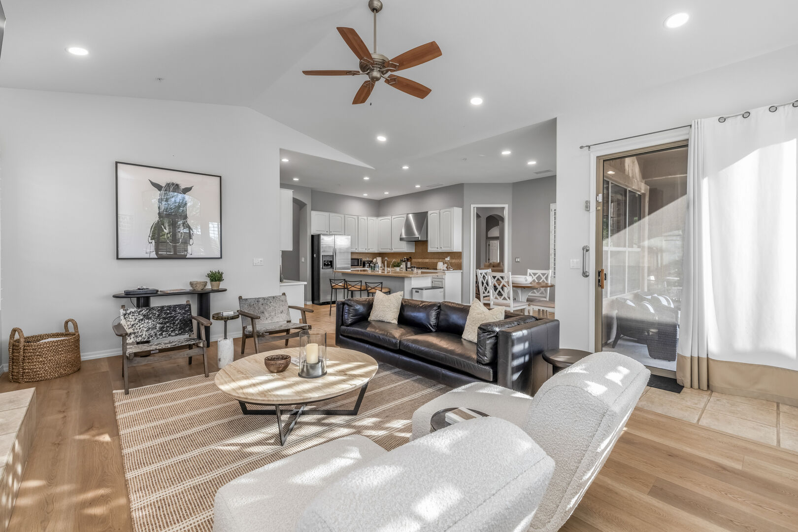 Offers leather sofa seating, accent chairs and a gas fireplace and opens to the kitchen area