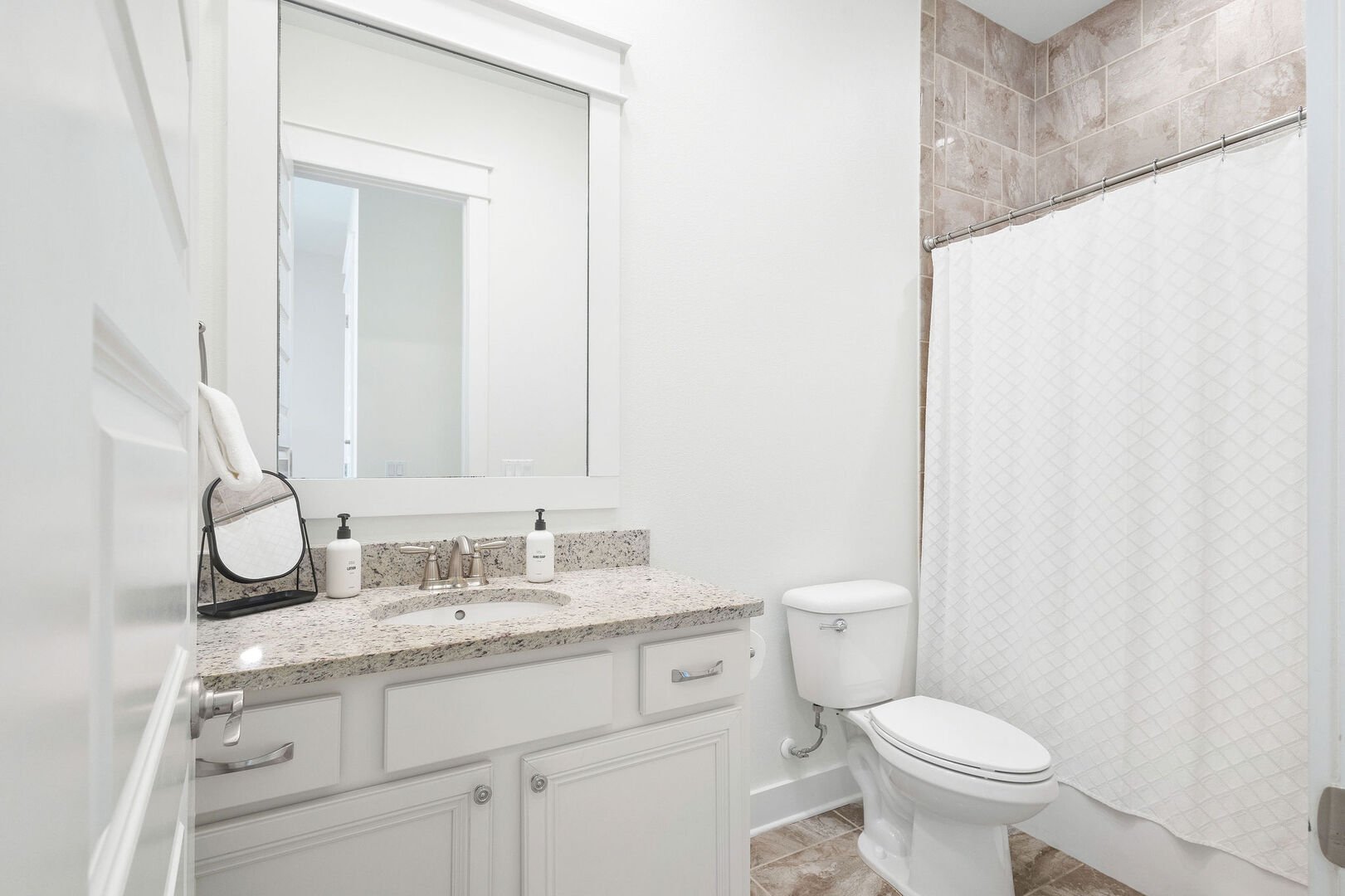 Bathroom features a shower/tub combo.