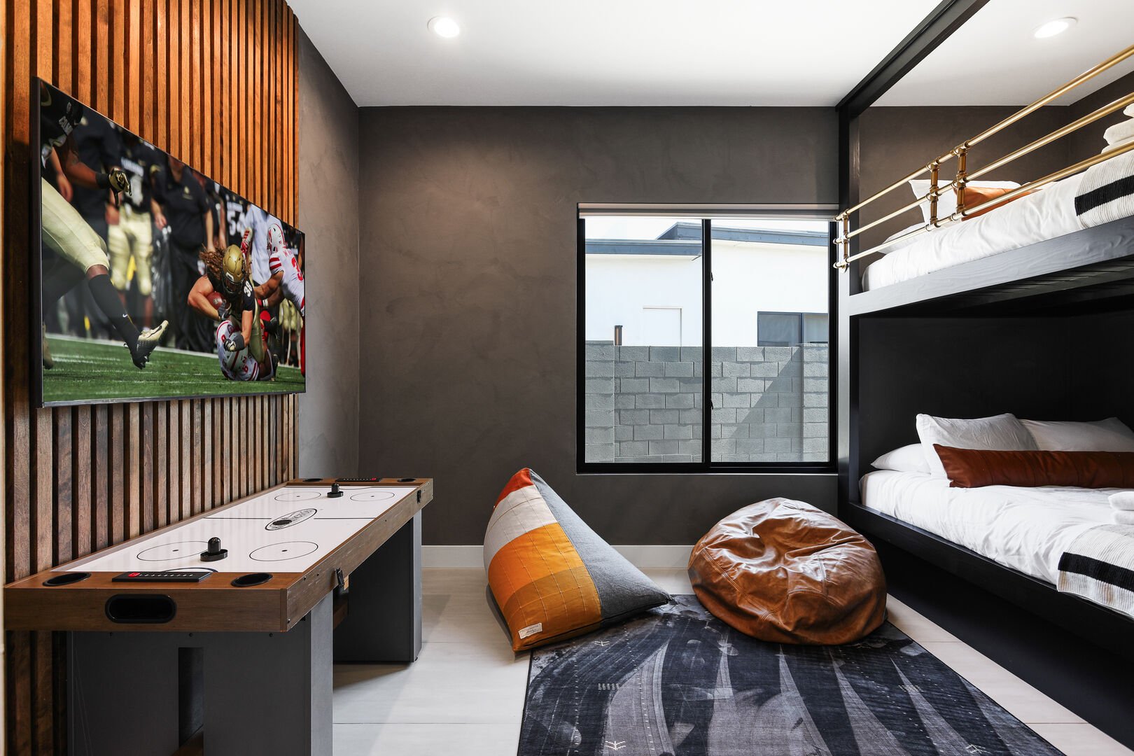 Unit 2: 5th Bedroom featuring 2 Full beds (Bunk Bed Style), Designer Furnishings, Smart TV, Air Hockey, and Walk-in Closet.