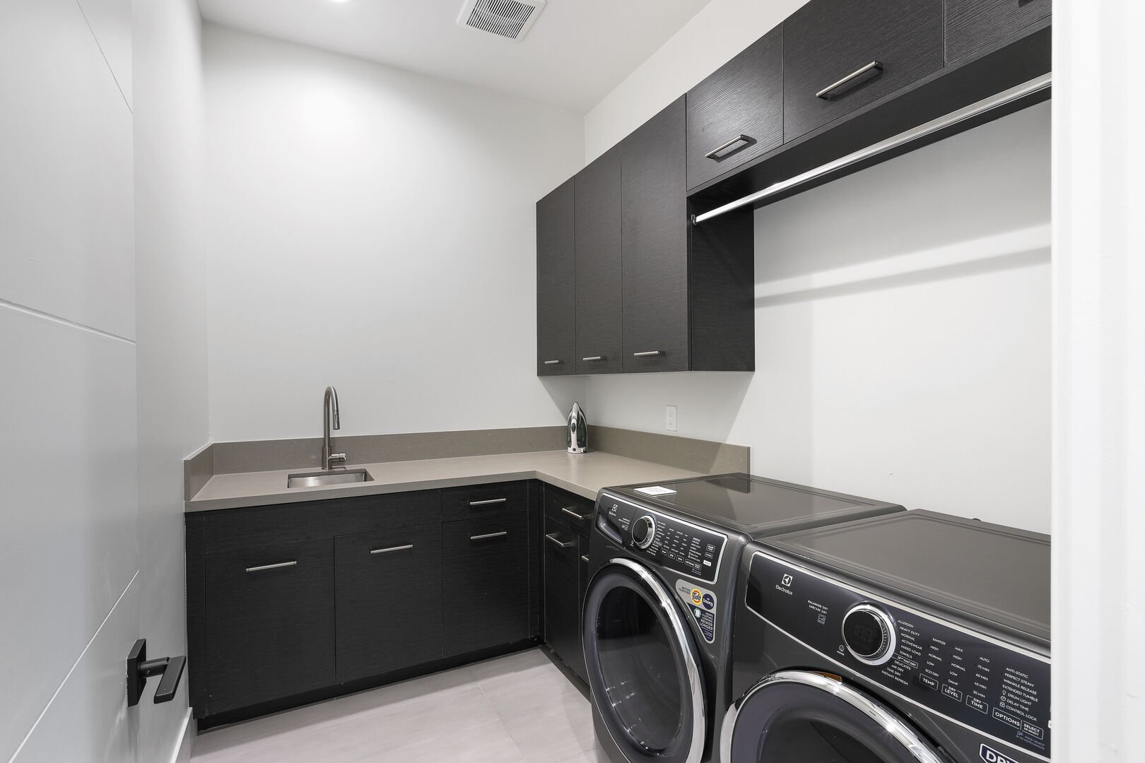 Unit 2: Laundry Room with a Washer, Dryer, and storage space.