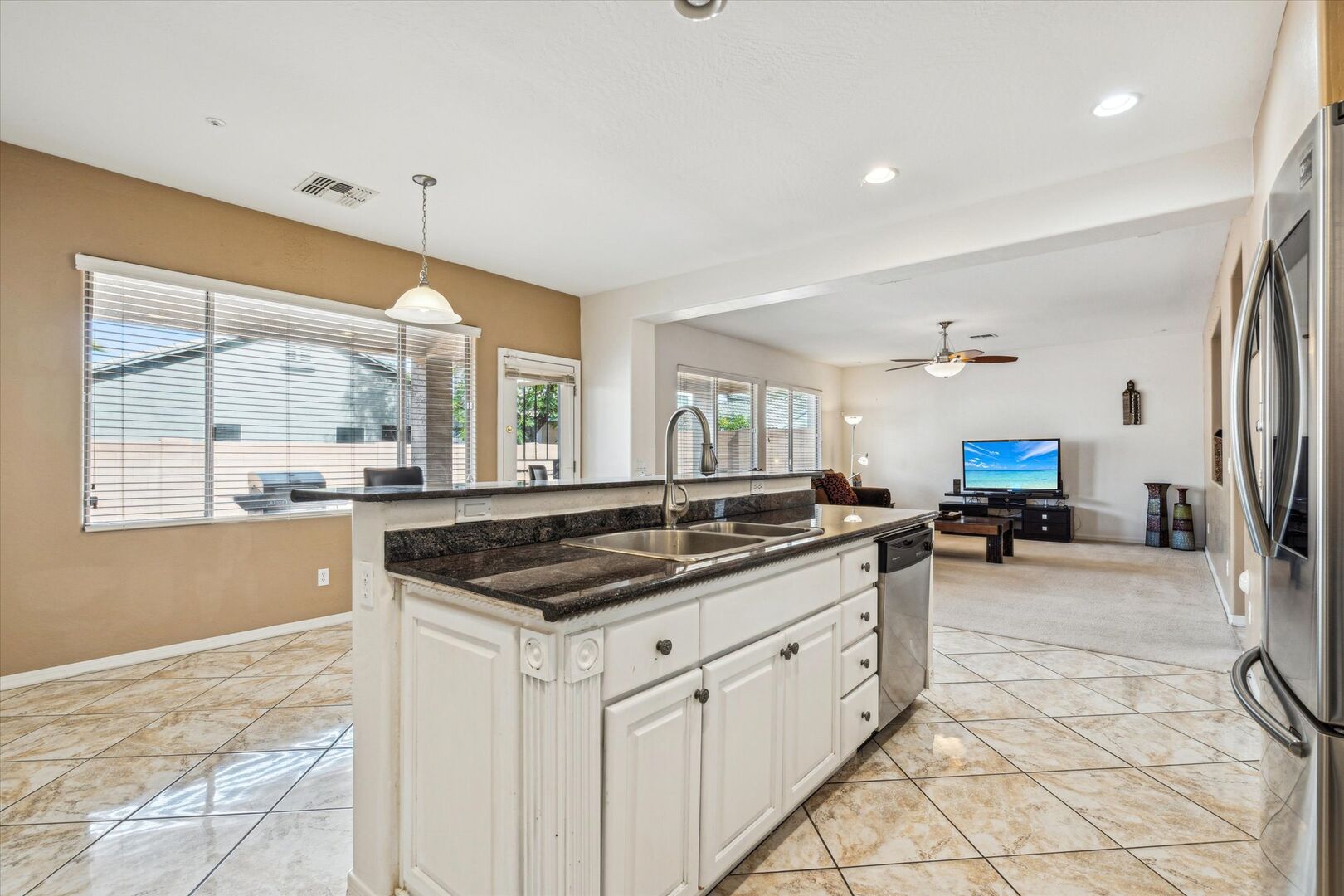 Fully equipped kitchen with stainless steal appliances and a kitchen island with bar seating for 3 guests.