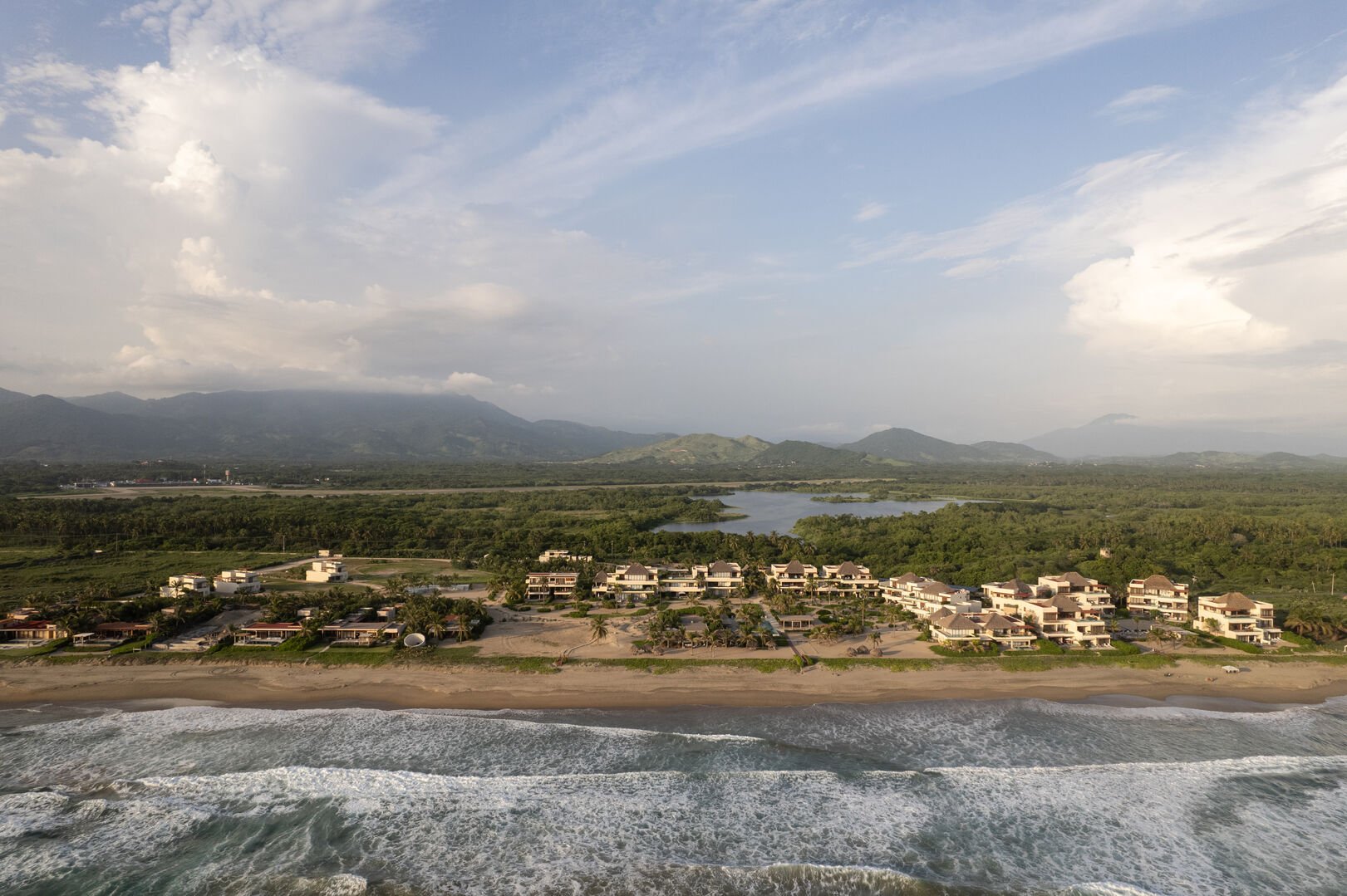 Located between lush greenery and the ocean, this serene community offers stunning views and private beach access.