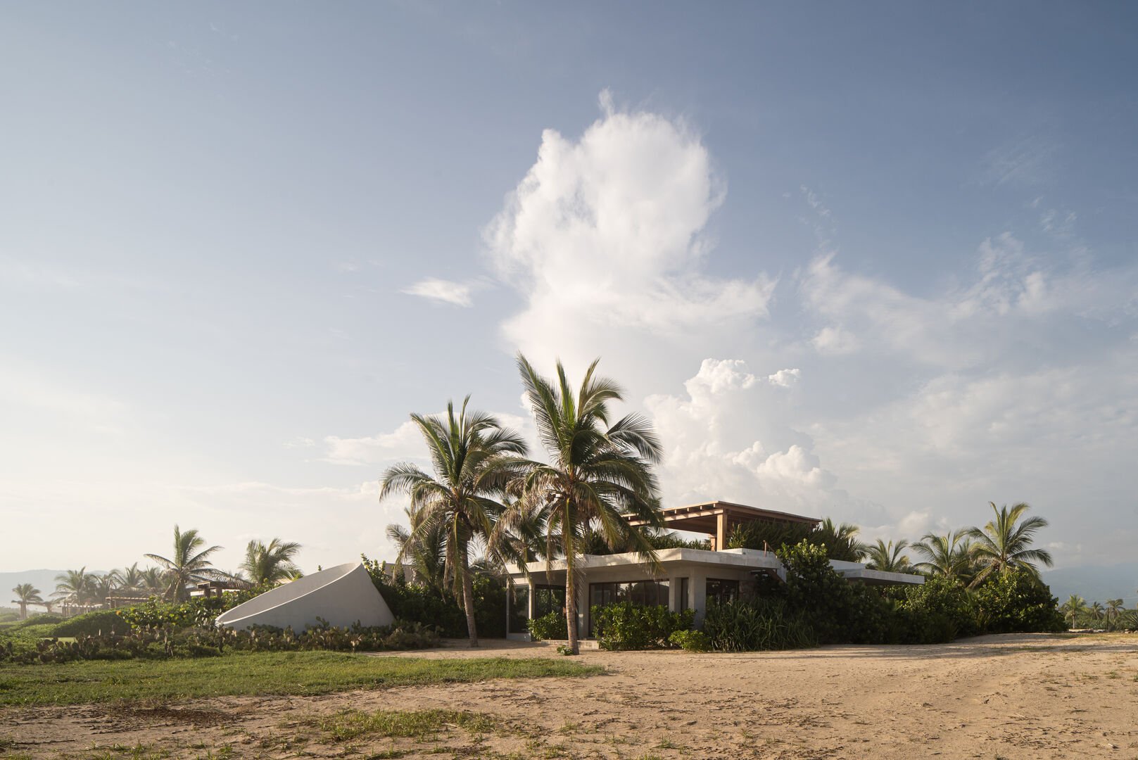 A private coastal retreat surrounded by lush palm trees, offering tranquility and breathtaking sunset views.