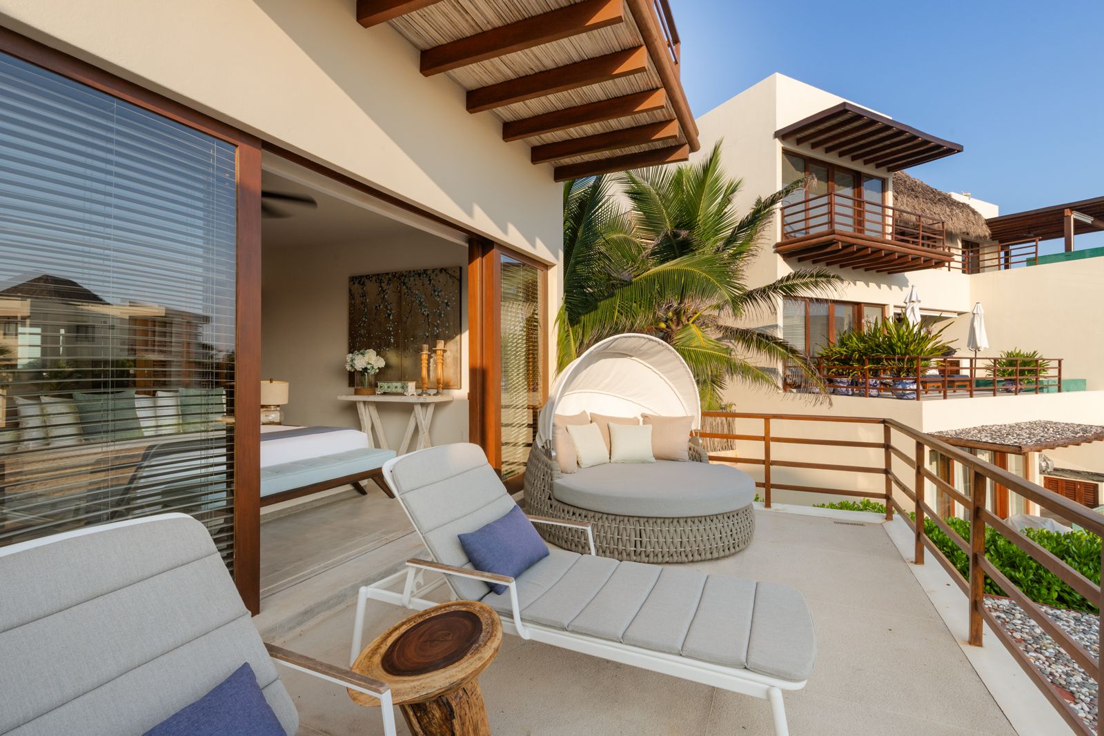 Unwind in this cozy terrace with plush seating, panoramic ocean views, and a shaded pergola for relaxation.