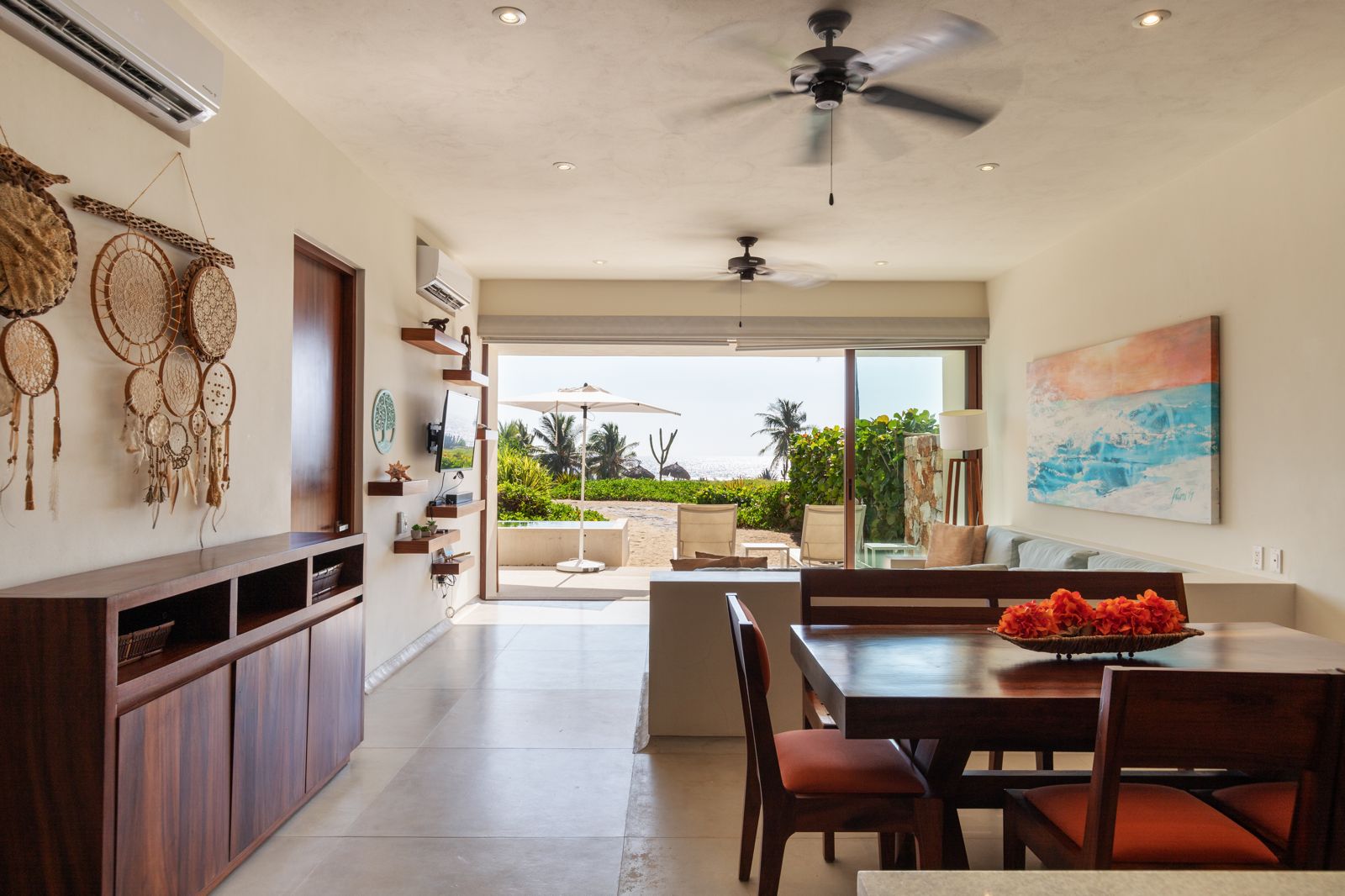 A welcoming entryway featuring handcrafted decor, woven textures, and warm lighting for a tropical ambiance.