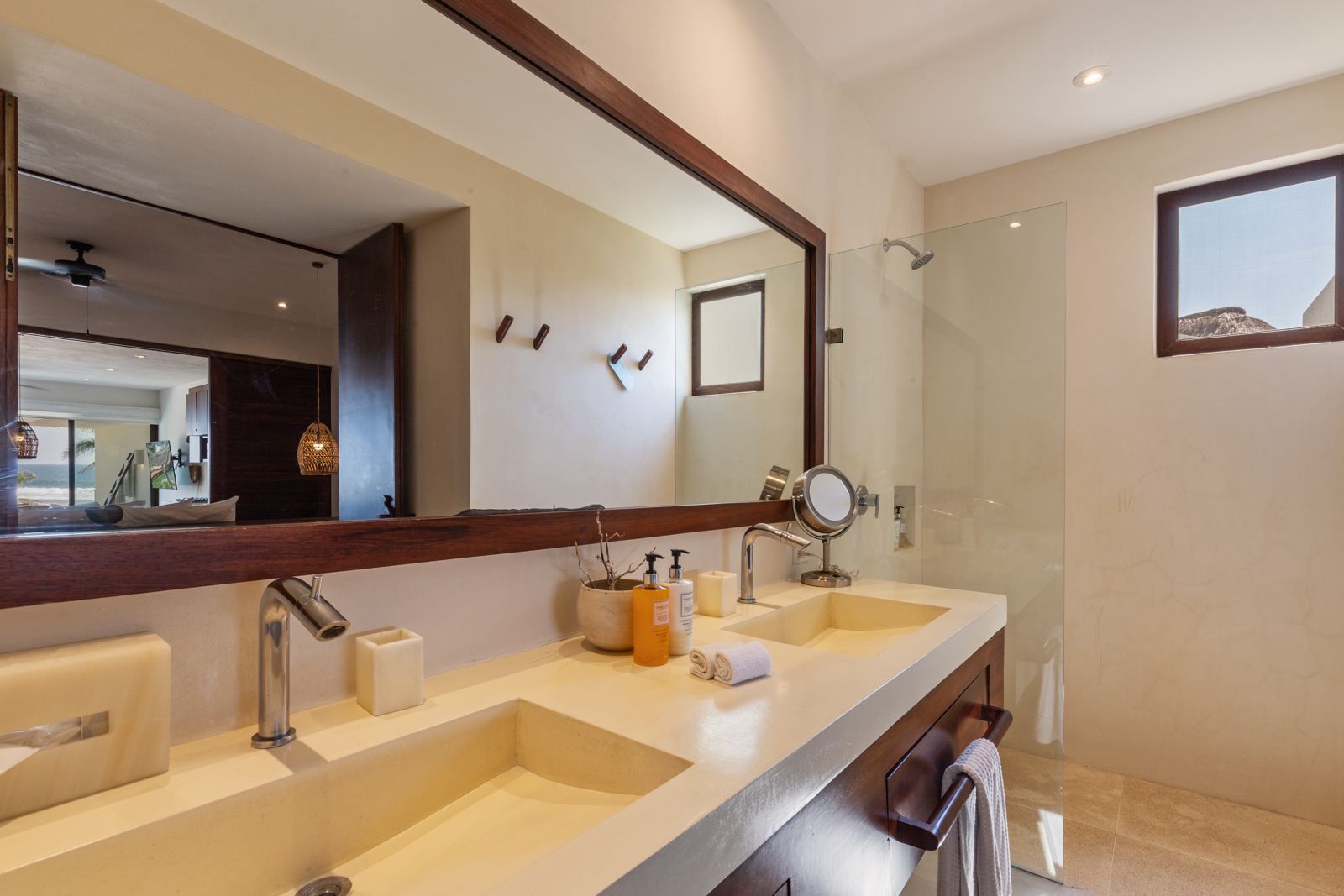 This double vanity bathroom exudes elegance with high-end fixtures, a spacious walk-in shower, and refined minimalist decor.