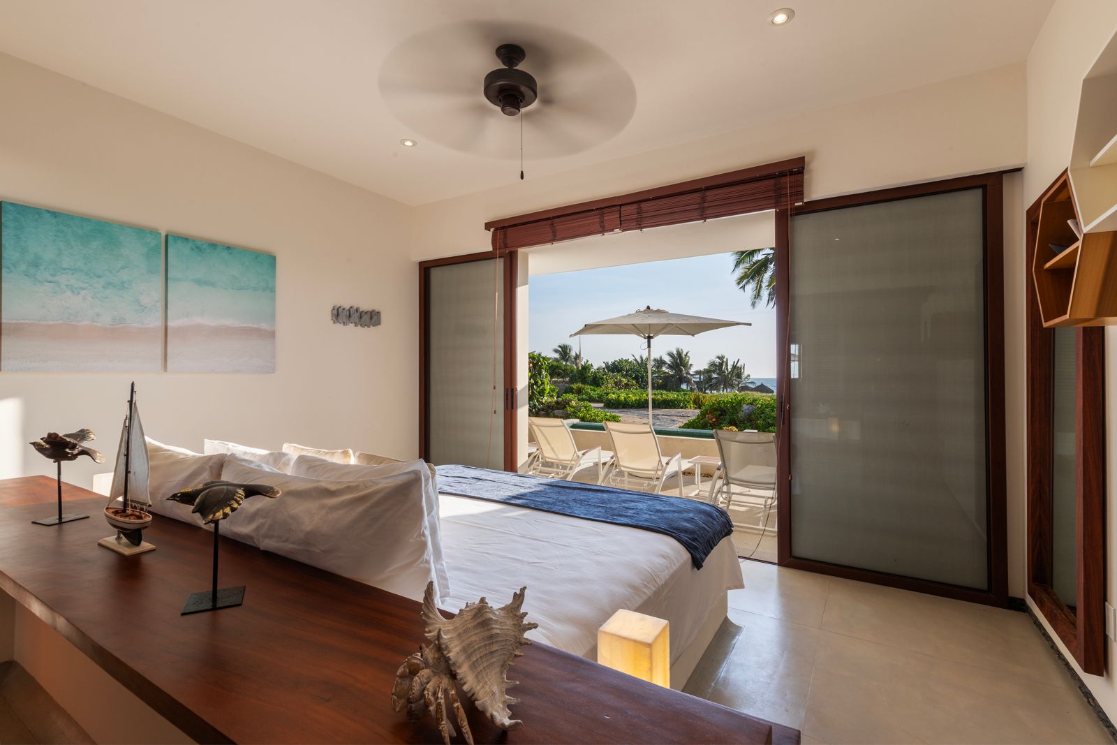 Spacious bedroom with floor-to-ceiling windows, a comfortable king-size bed, and a private patio entrance.