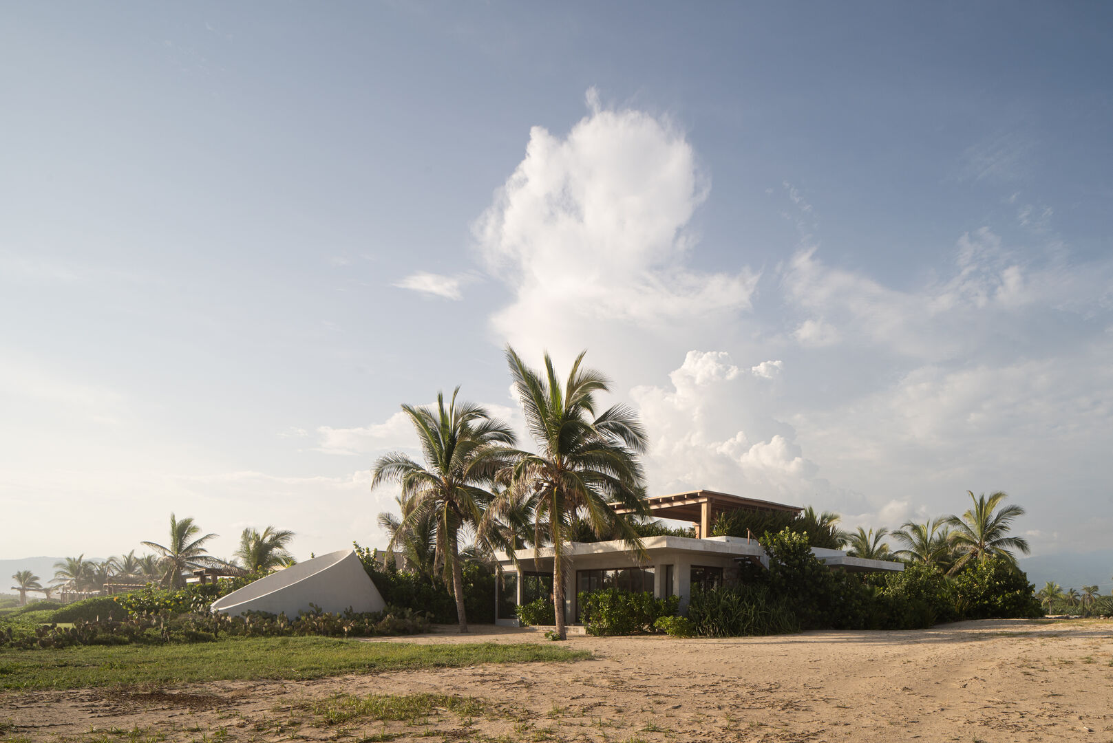 A private coastal retreat surrounded by lush palm trees, offering tranquility and breathtaking sunset views.