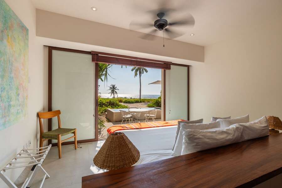 Wake up to stunning ocean views in this elegant master suite, featuring sliding doors leading to a private patio.