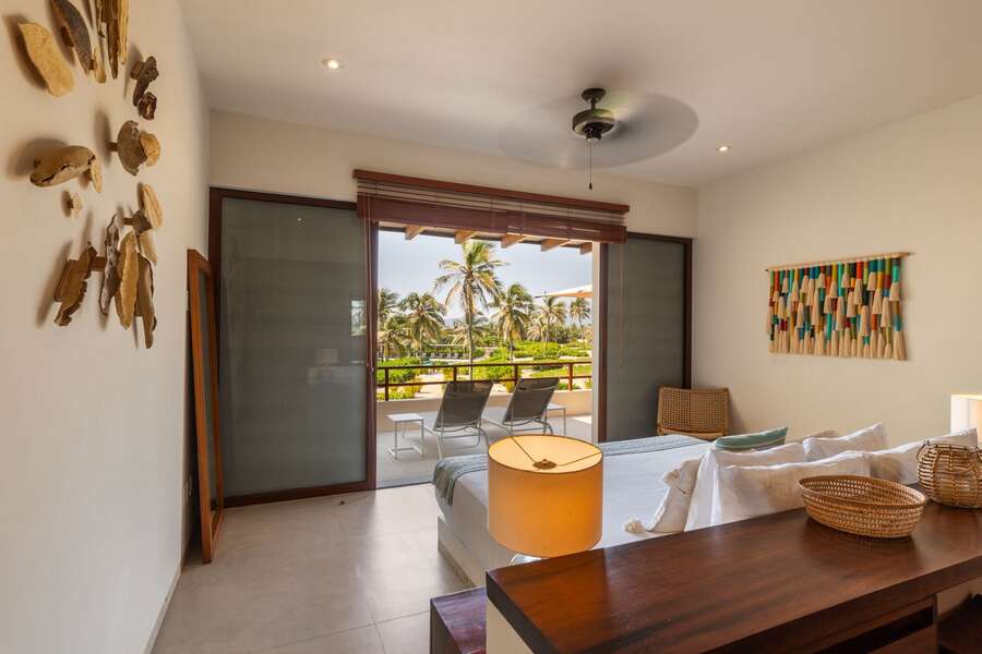 Wake up to breathtaking sunrises in this stylish and cozy bedroom, featuring direct access to the outdoor lounge area.