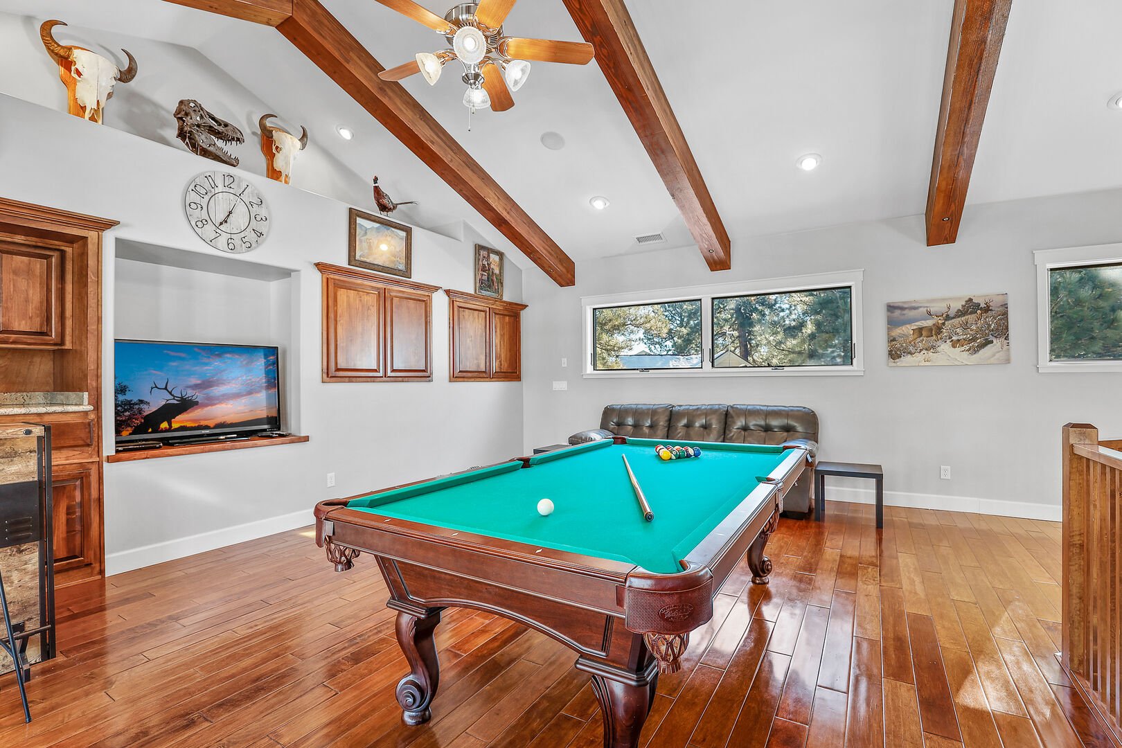 Game Room - Second Floor: Featuring a full-sized pool table, bar area, loveseat, and flat-screen cable TV. This space also offers access to a private balcony overlooking the front yard, making it perfect for group fun and connection.