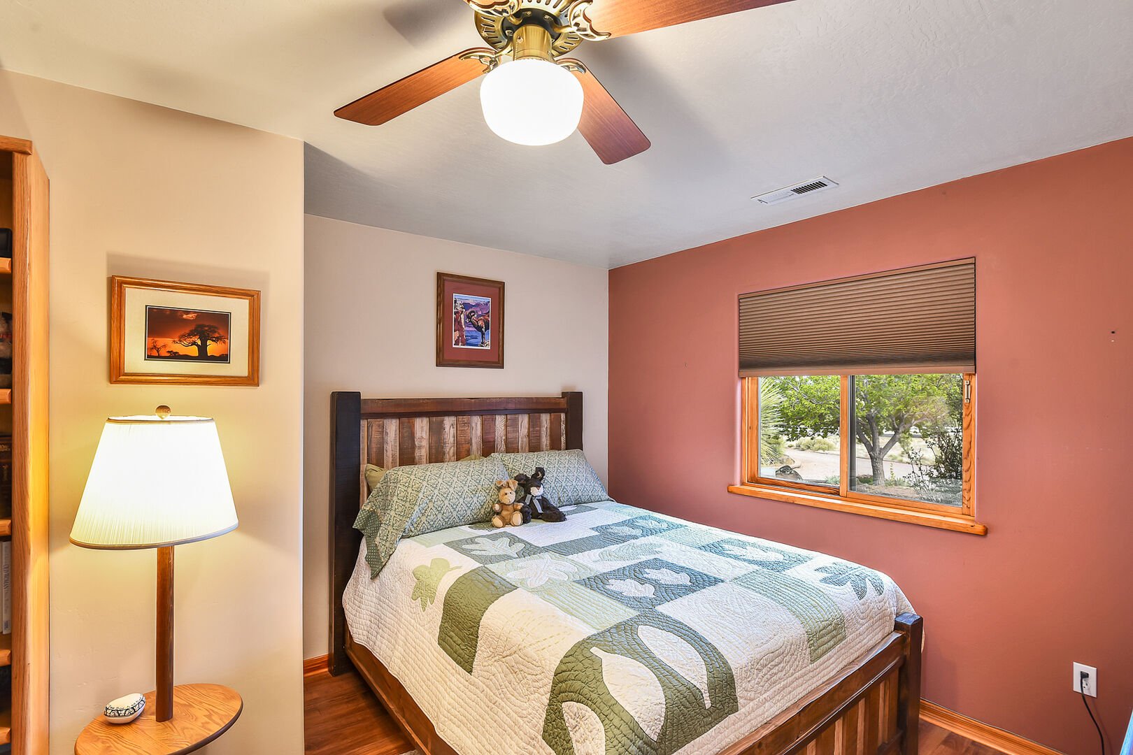 Queen-sized bed with a cozy reading nook, located near the half-bathroom.