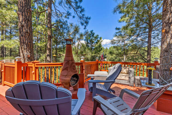 Outdoor Living: Upper and lower decks with seating, a grill, a firepit and serene views, perfect for relaxation and gatherings.