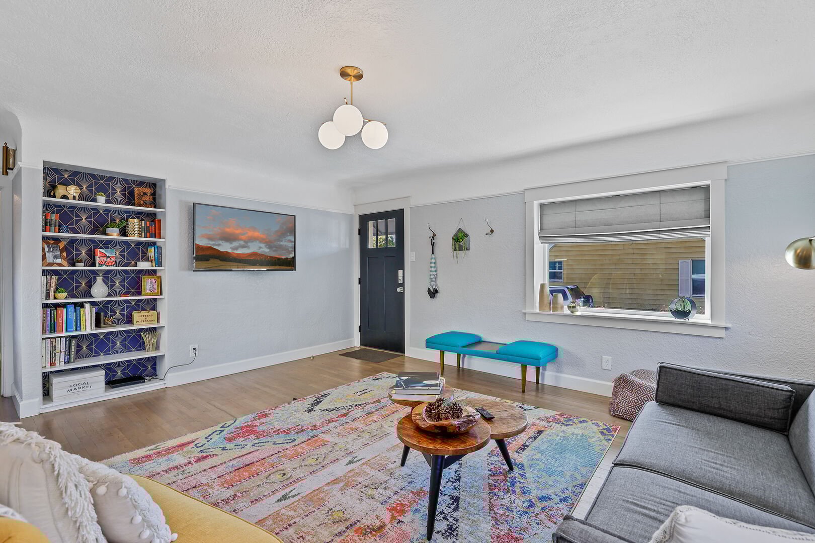 Chic Living Space: A perfect blend of modern comfort and mid-century decor, featuring beautifully restored wooden floors and doors.