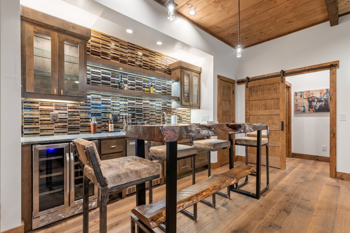 Sit with drinks or play board games on the reclaimed pine bar top with forged iron and hair hide artisan stools handmade in England.