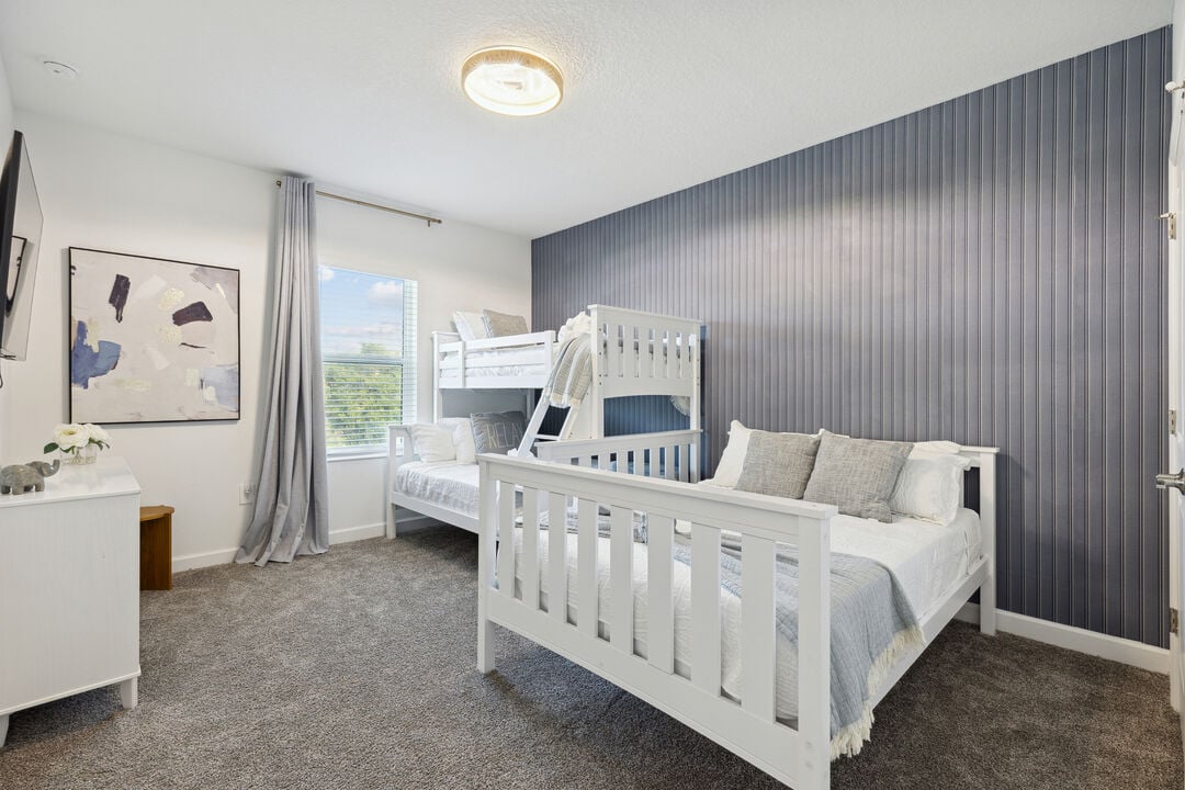 Charming kids' room with bunk beds and playful, cozy decor.
Serene master bedroom with modern accents and natural light.