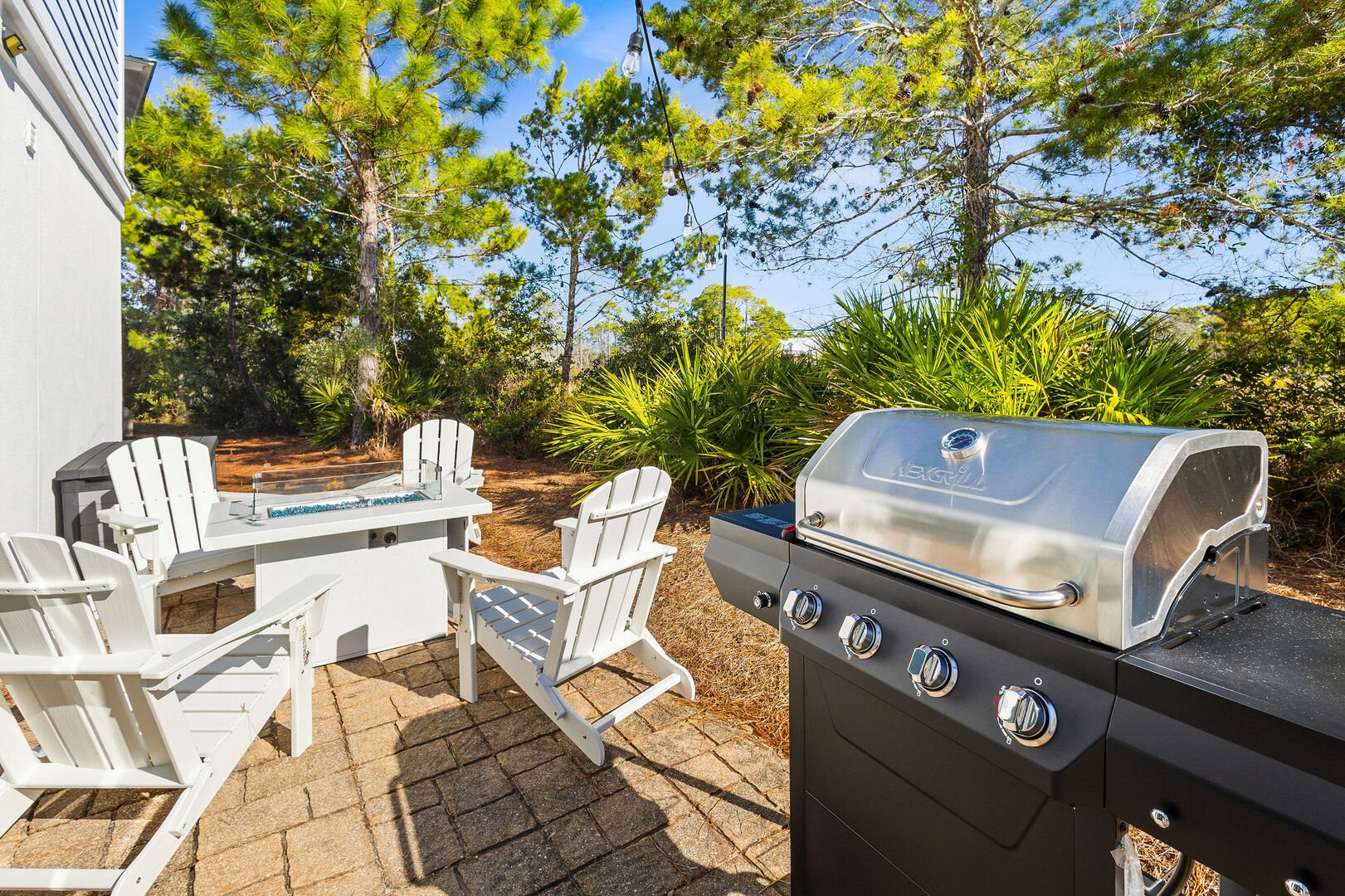 Patio off dining room features a fire pit and gar grill.