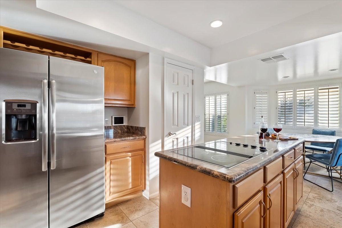 The fully equipped modern kitchen is stocked with all culinary essentials, stainless-steel appliances and dining area.