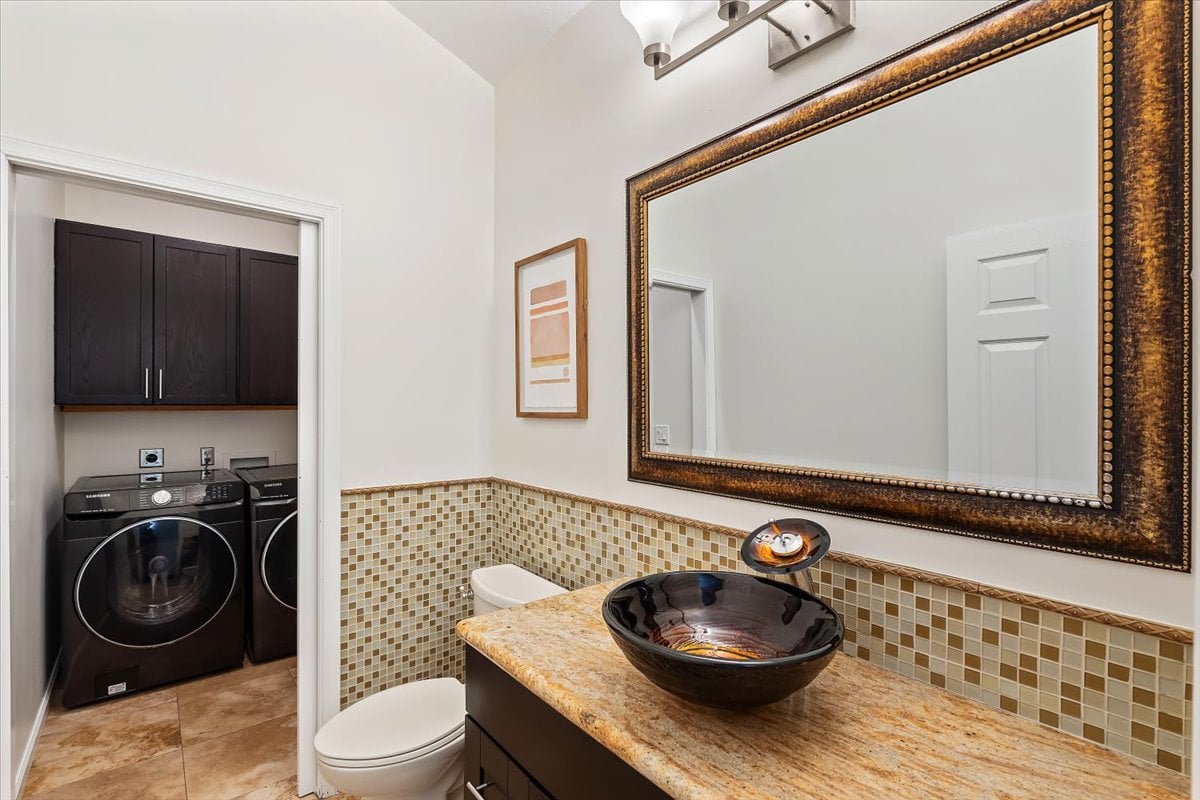 Half bathroom, with a washer and dryer for your convenience.