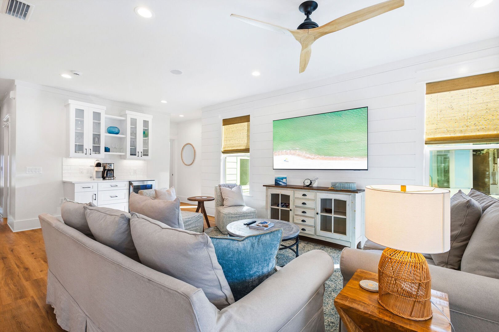 Living room features plenty of seating and a smart tv.