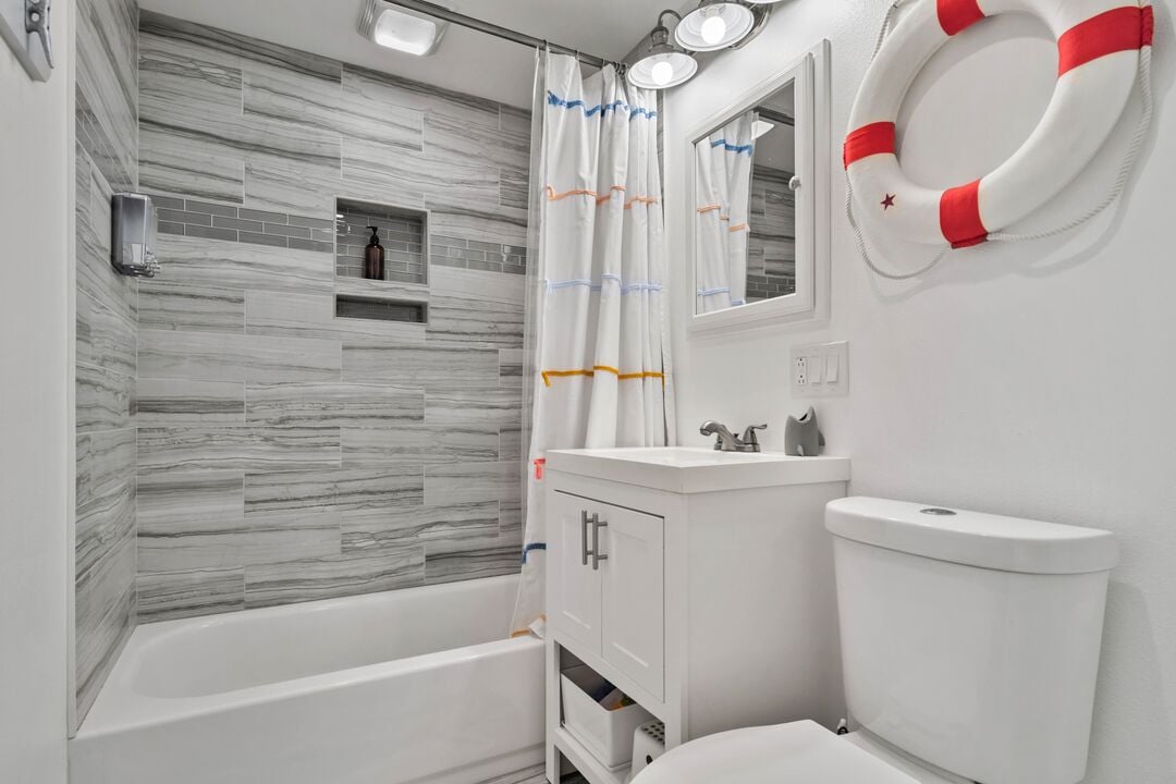 A pristine white bathroom featuring a shower and tub combination.
