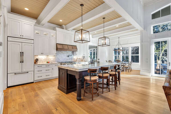 The chef's kitchen boasts high-end appliances, including a gas range and pot filler, perfect for cooking family meals or entertaining.