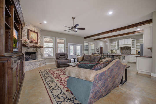 The living room features a stone fireplace, creating a cozy atmosphere for gathering.