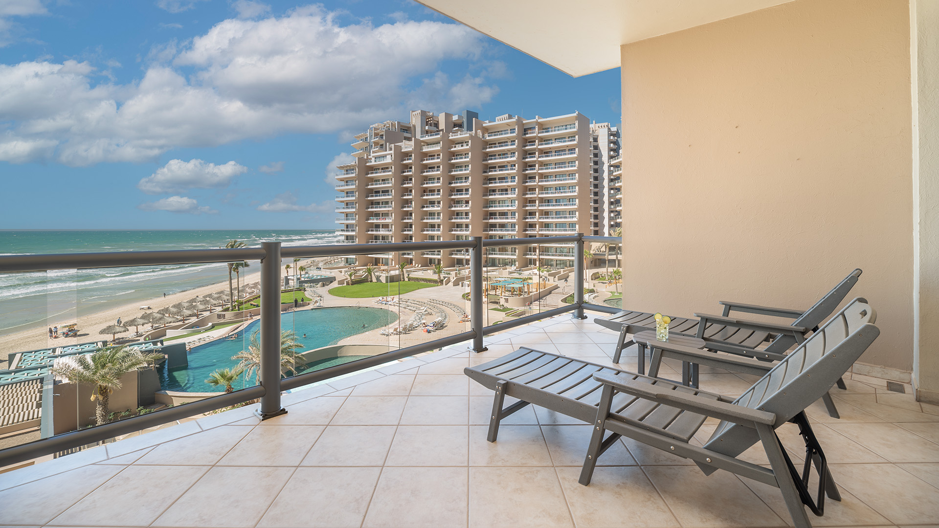 Chaise lounge chairs on the balcony near the beach