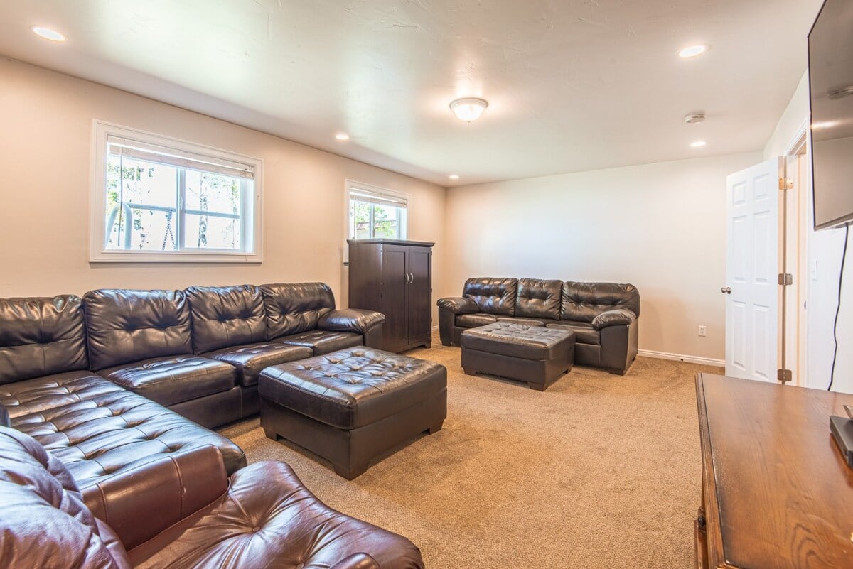 This family room features a large TV and plenty of seating.