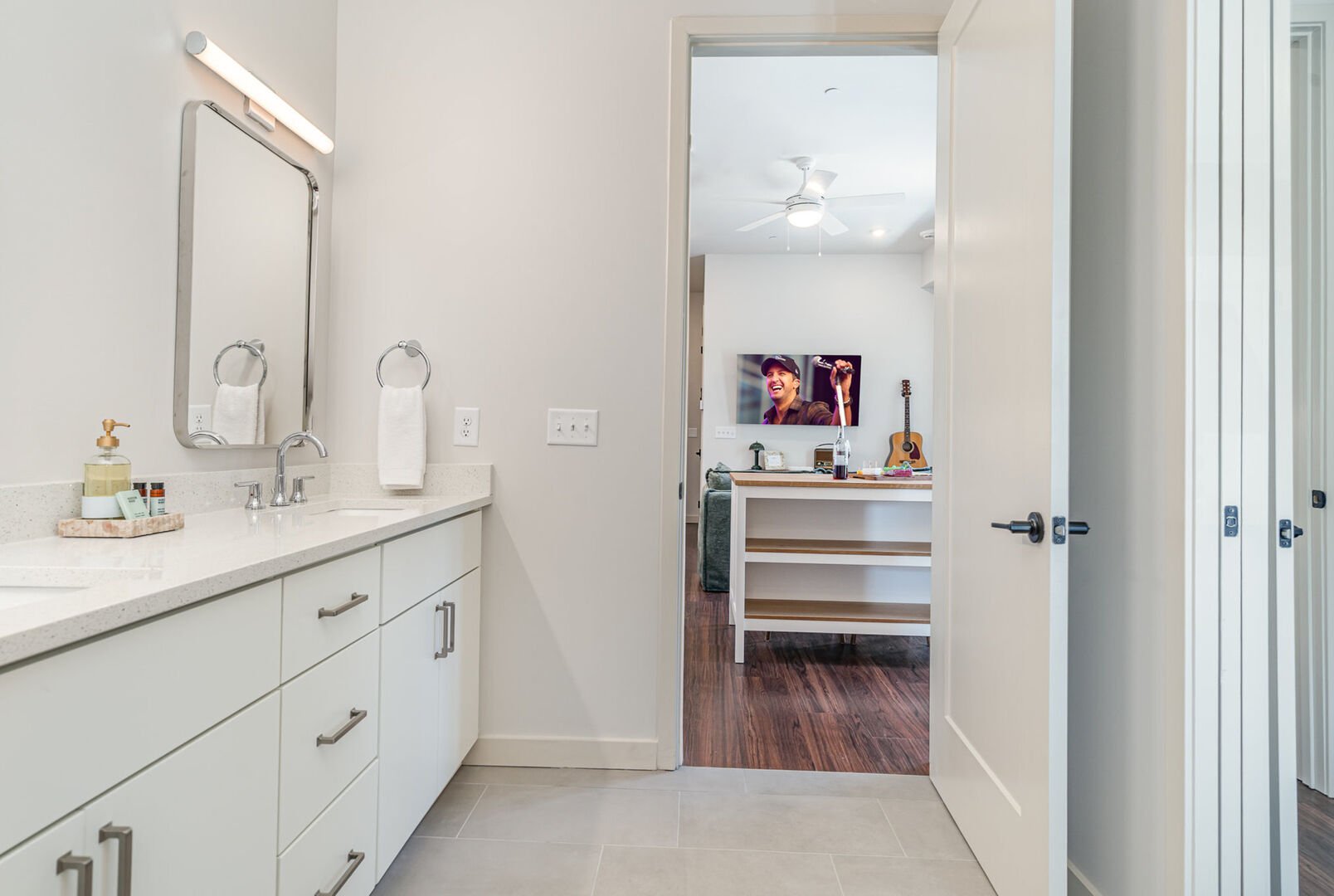 Primary Jack and Jill Bathroom with a double vanity and shower/tub combo, seamlessly connecting the primary bedroom to the main living area.
