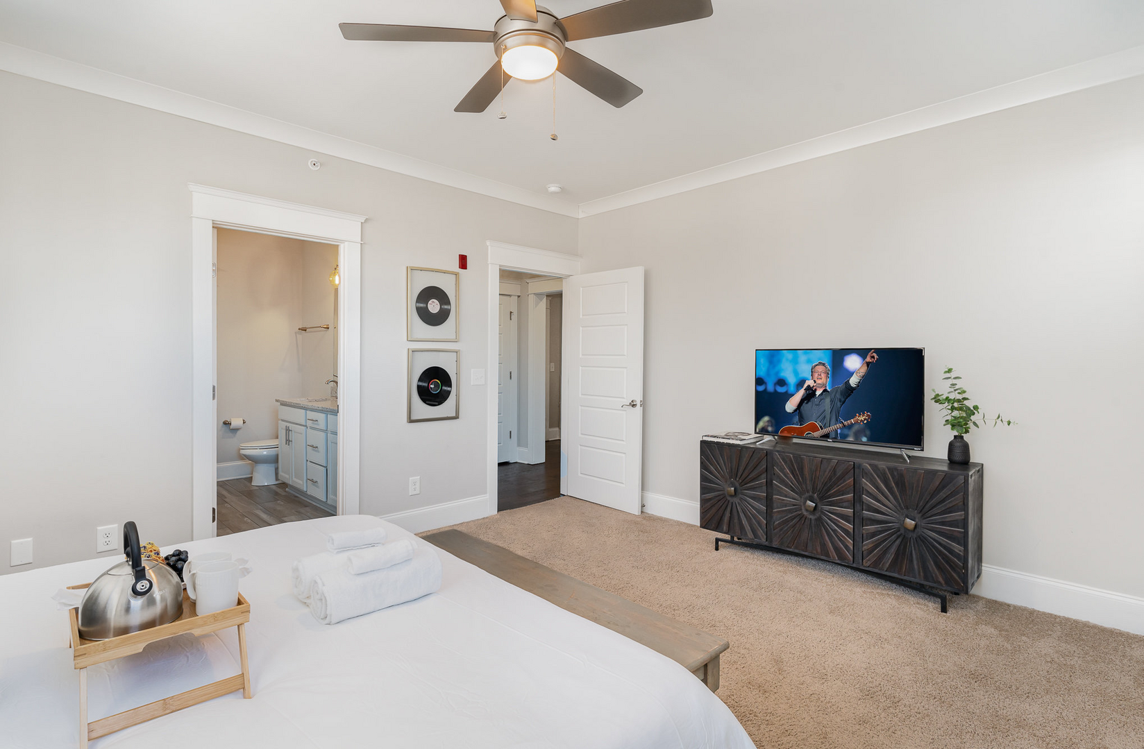 Unit 3 (3rd Floor): Primary bedroom with a King bed with smart TV and en-suite bathroom with large walk-in closet.