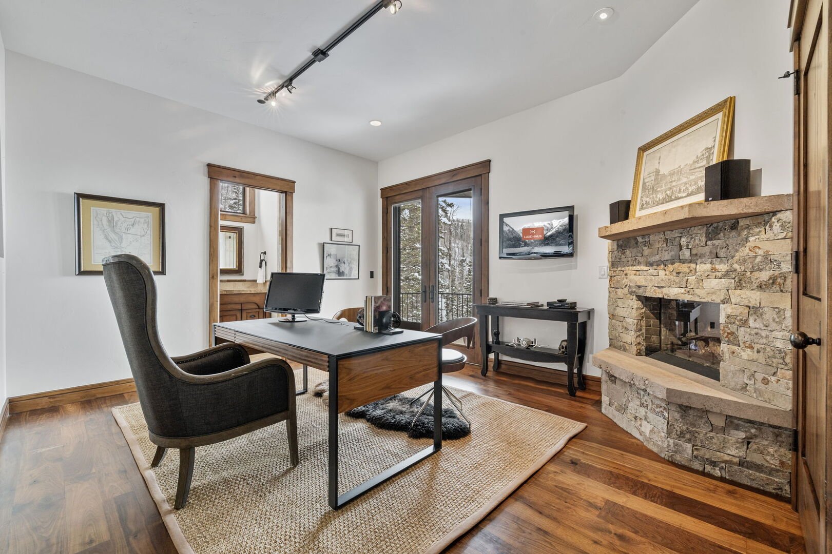 home office with stone fireplace and view of the mountains