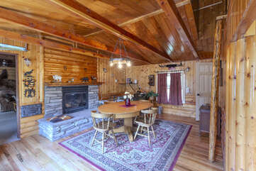 Entrance into the dining area with a dining table and a fireplace, make sure to bring your own wood.
