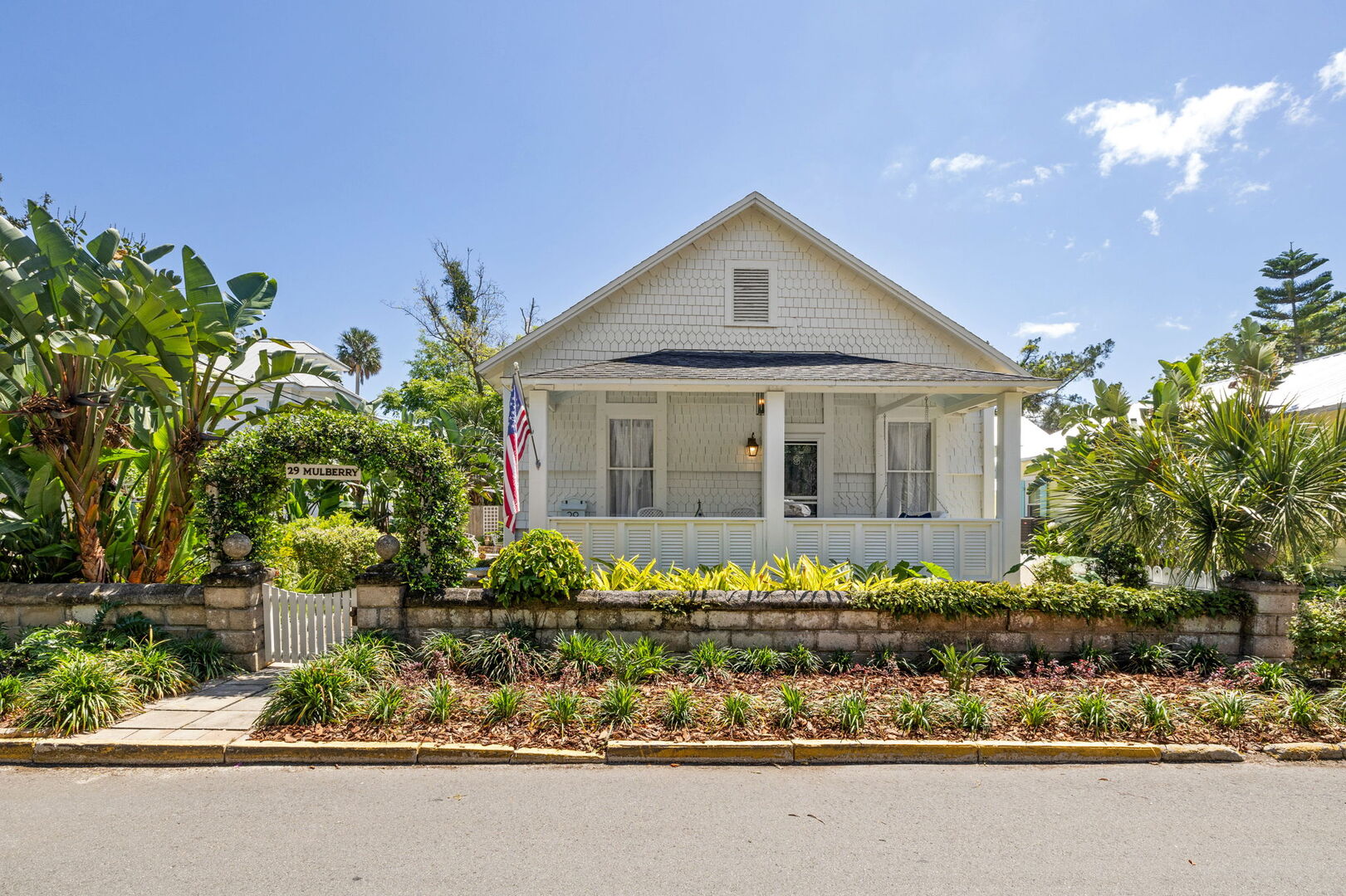 Welcome to Mulberry 1897!
View point on the northside of the home. Front patio with front porch swing and bistro table.
