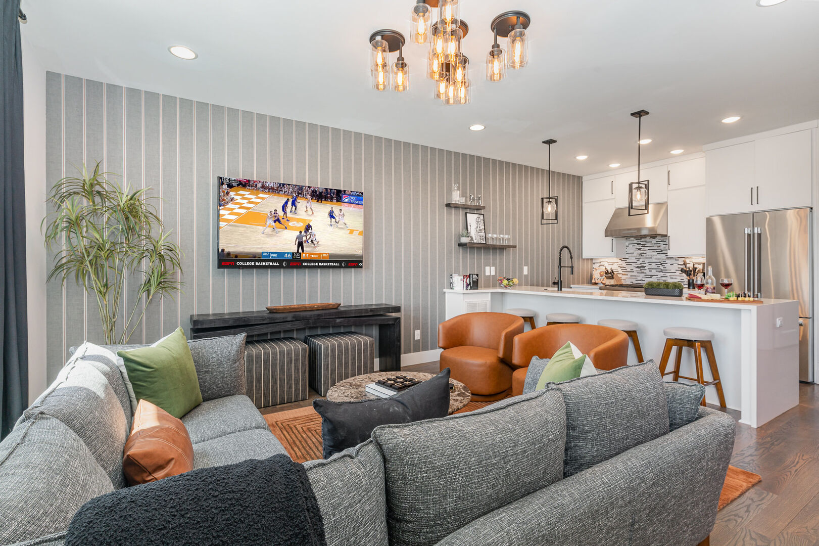 1st Unit (2nd Floor): Open-floor living space featuring a Smart TV and designer furnishings.