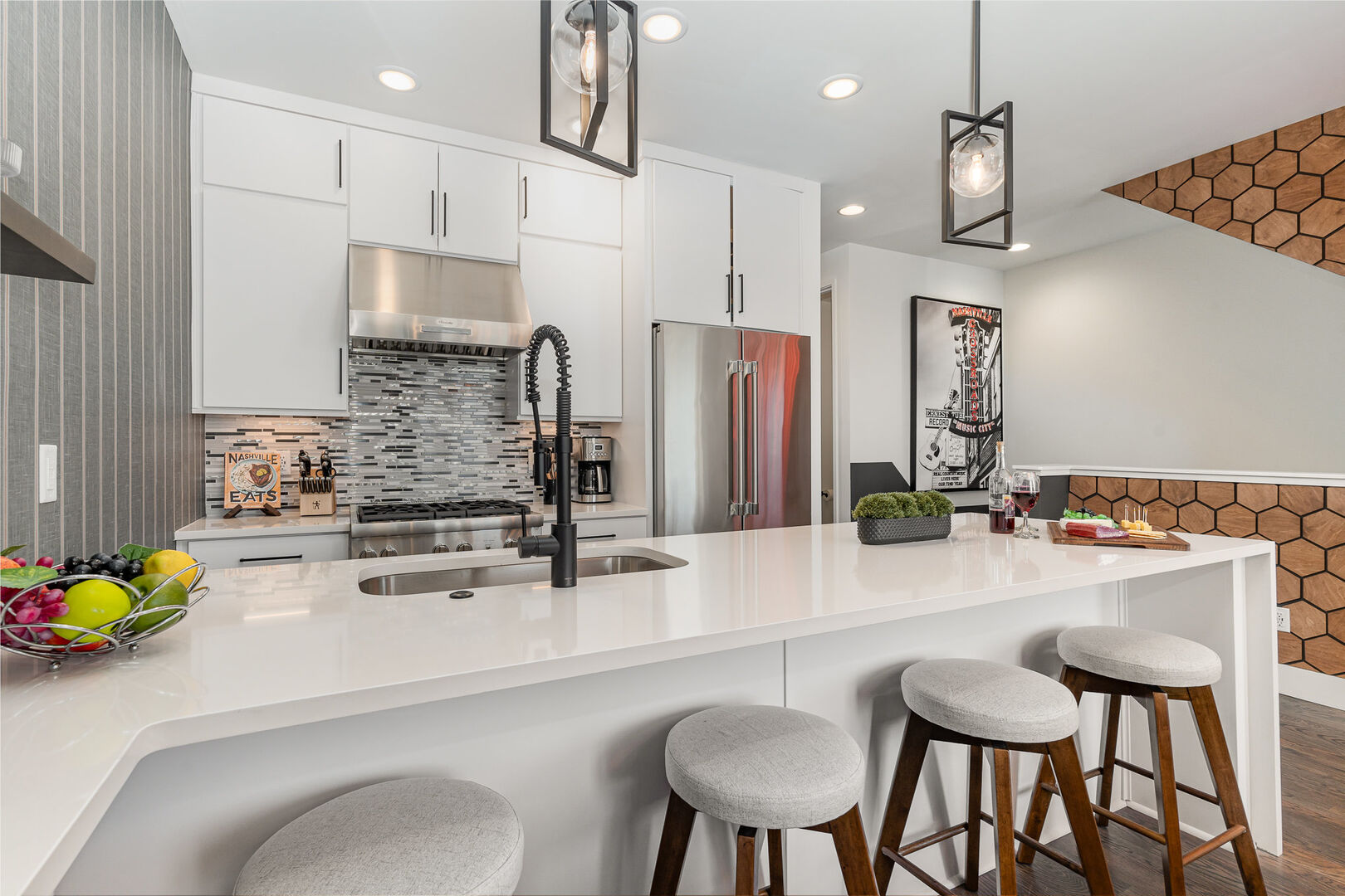 1st Unit (2nd Floor): Fully equipped kitchen with stainless steel appliances and a kitchen island with seating for 4 guests.