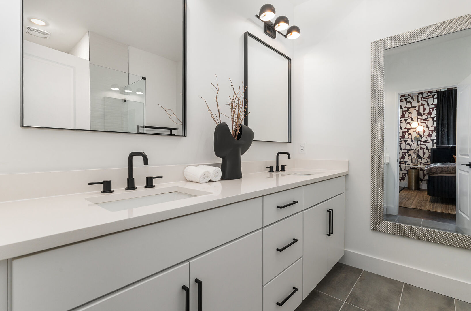 1st Unit (3rd Floor): Primary Bathroom featuring a dual vanity and a large stand-in shower.