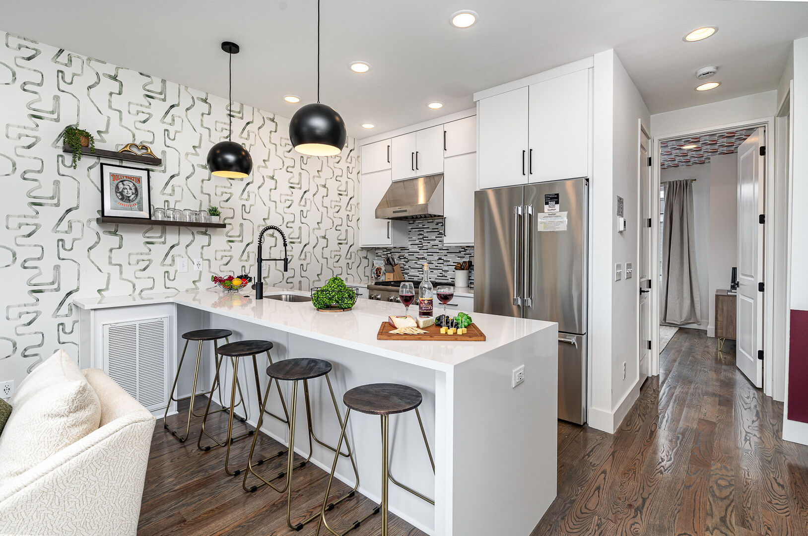 3rd Unit (2nd Floor): Fully equipped kitchen with stainless steel appliances and a kitchen island with seating for 4 guests.